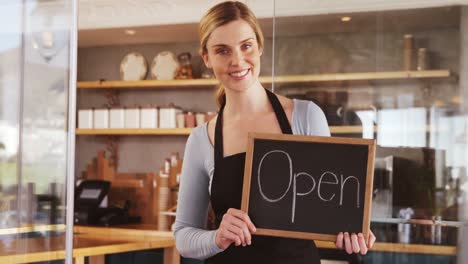 Smiling-waitress-with-chalkboard