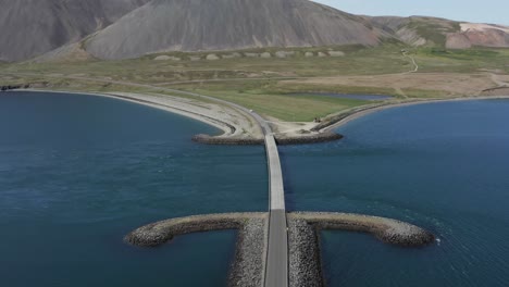 anchor shaped breakwater at kolgrafafjörður fjord entrance with bridge