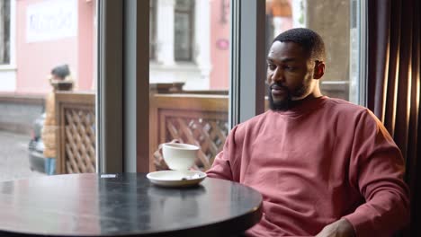 man sitting in restaurant with cup of tea. lifestyle