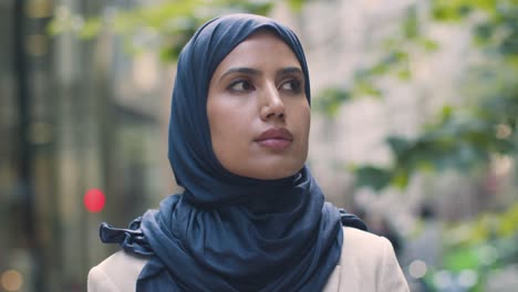 portrait of muslim businesswoman outdoors standing in front of city offices 4