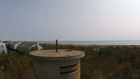 drone shot rises above world war ii watchtower to view of atlantic ocean