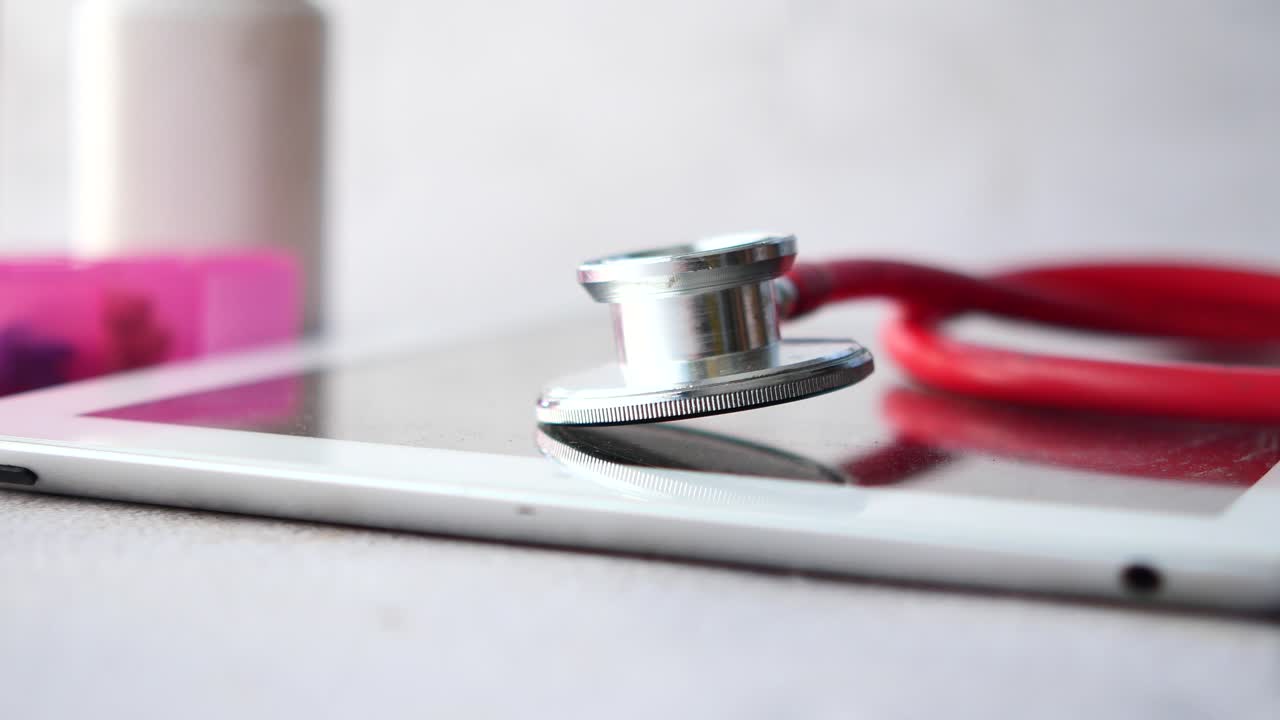 Medical stethoscope on modern digital tablet on white background
