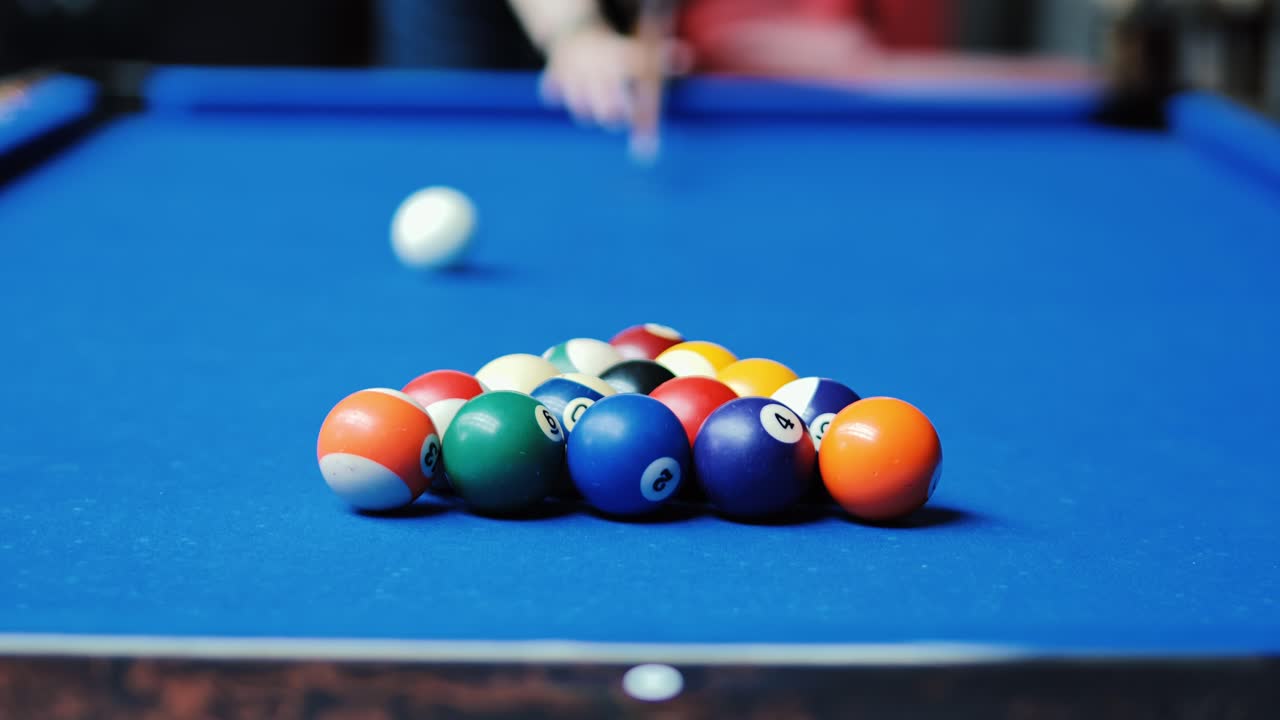 Missed opening break shot on bright blue billiard table as cue ball veers wide