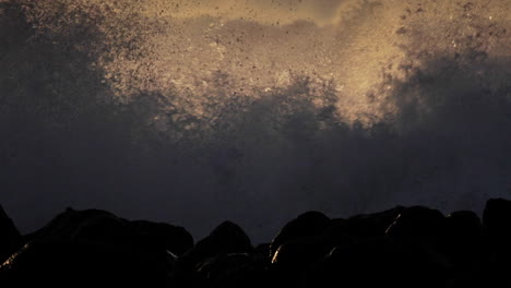 huge waves roll in and crash against a rocky shoreline 3