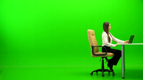 the woman relaxing at the table on the green background