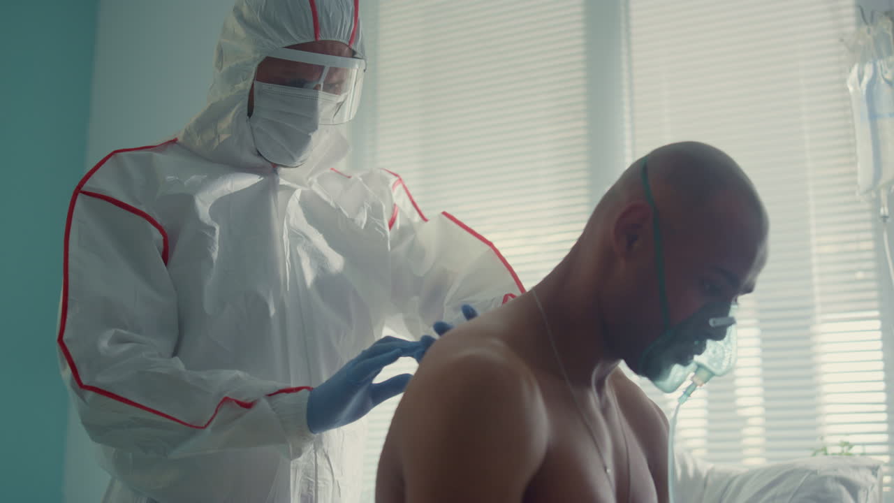 Physician examining sick patient back in clinic covid19 infectious department.