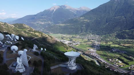 Teleport-and-data-center-in-leuk-in-switzerland,-satellite-dishes-in-idyllic-scenery,-green-mountain-valley