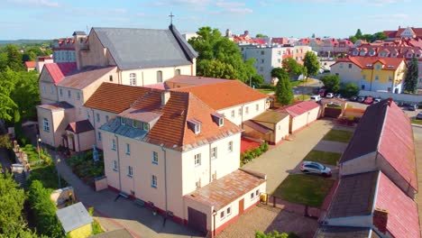 urban sprawl of village in northern poland, low to high aerial shot
