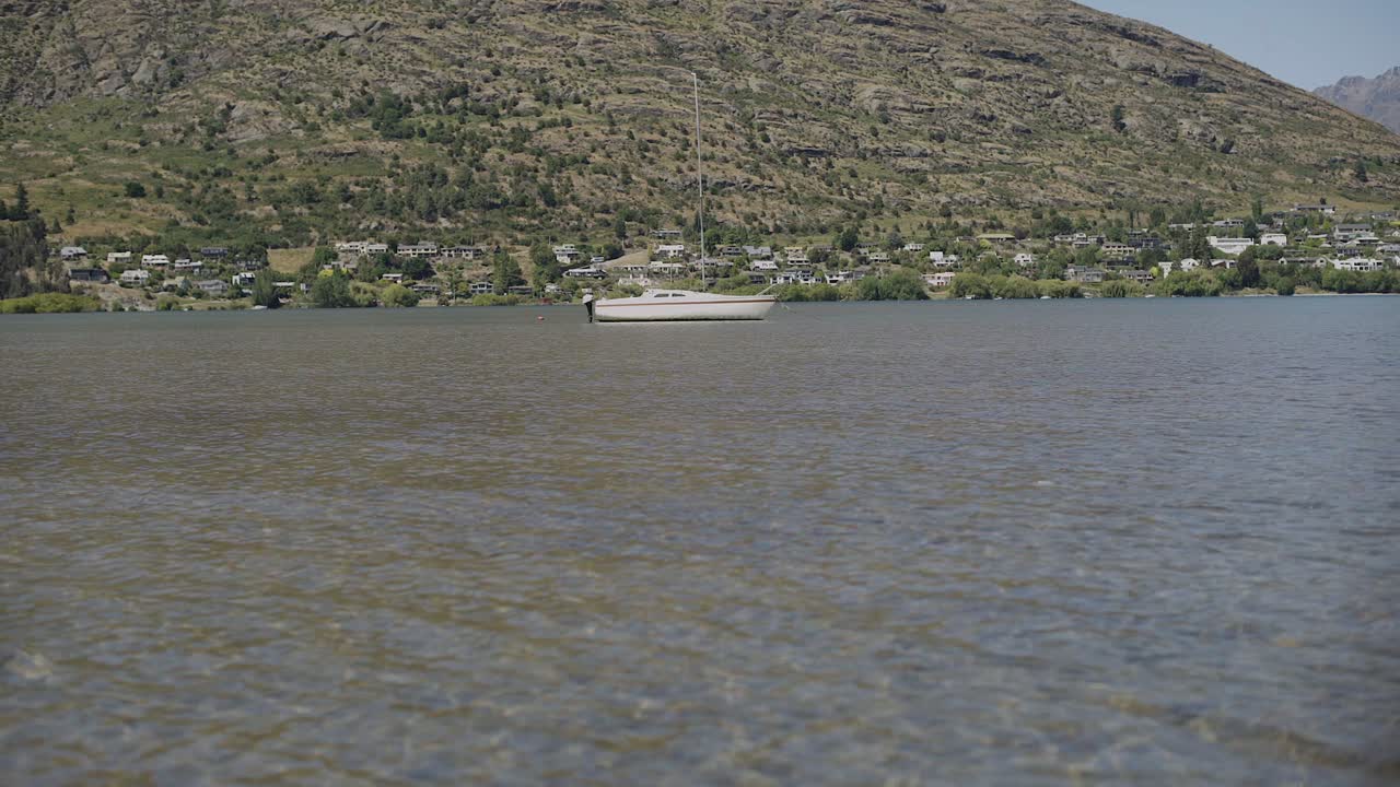 a yacht floating on the lake of lake wakatipu