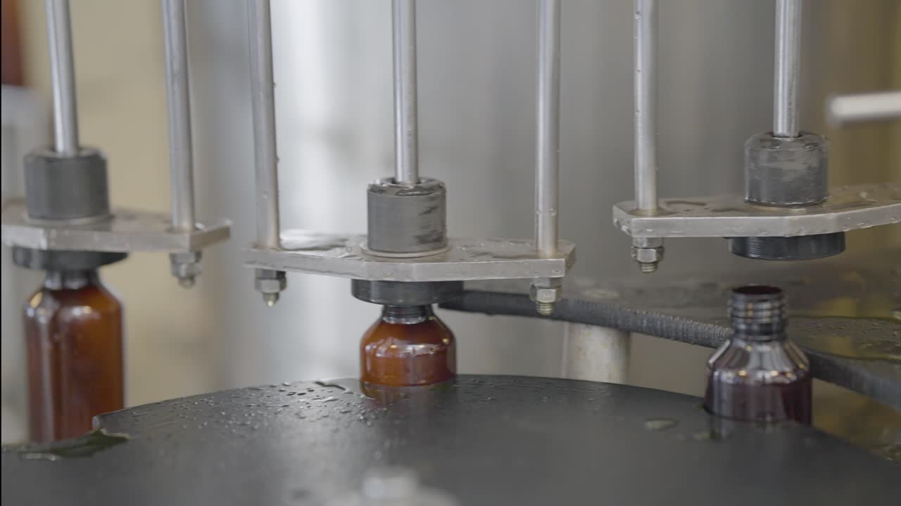 Syrup Bottles getting filled with liquid medicine close up shot.
