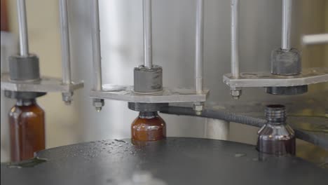 syrup bottles getting filled with liquid medicine close up shot.