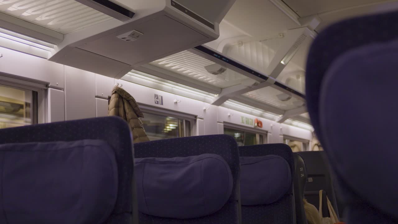 Empty seats and soft lighting inside a modern German ICE high-speed train