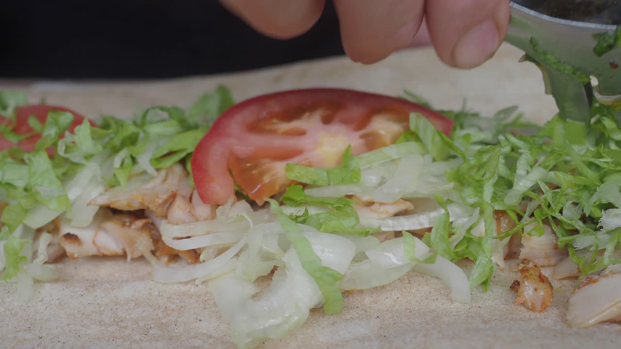 Preparing a Fresh Kebab Wrap with Chicken and Vegetables