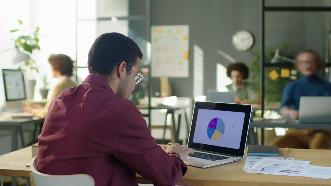 Timelapse of Financial Analyst Working on Laptop in Office
