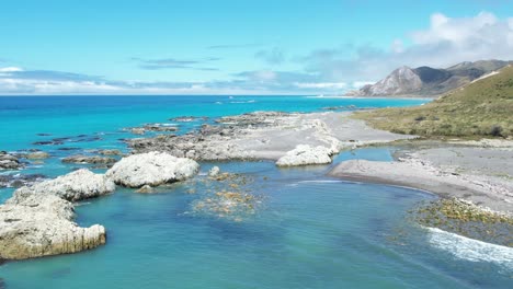 drone flying out to sea showing rocky outcrops