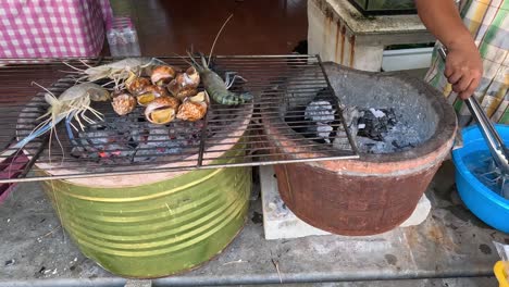 sequential grilling of seafood over open charcoal