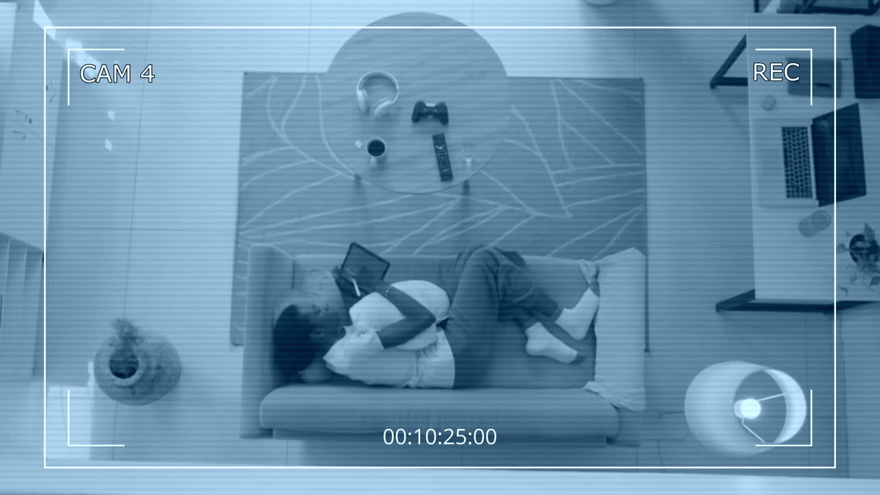 Relaxed Female Freelancer Lying on Couch with Tablet Hidden Cam Top Shot