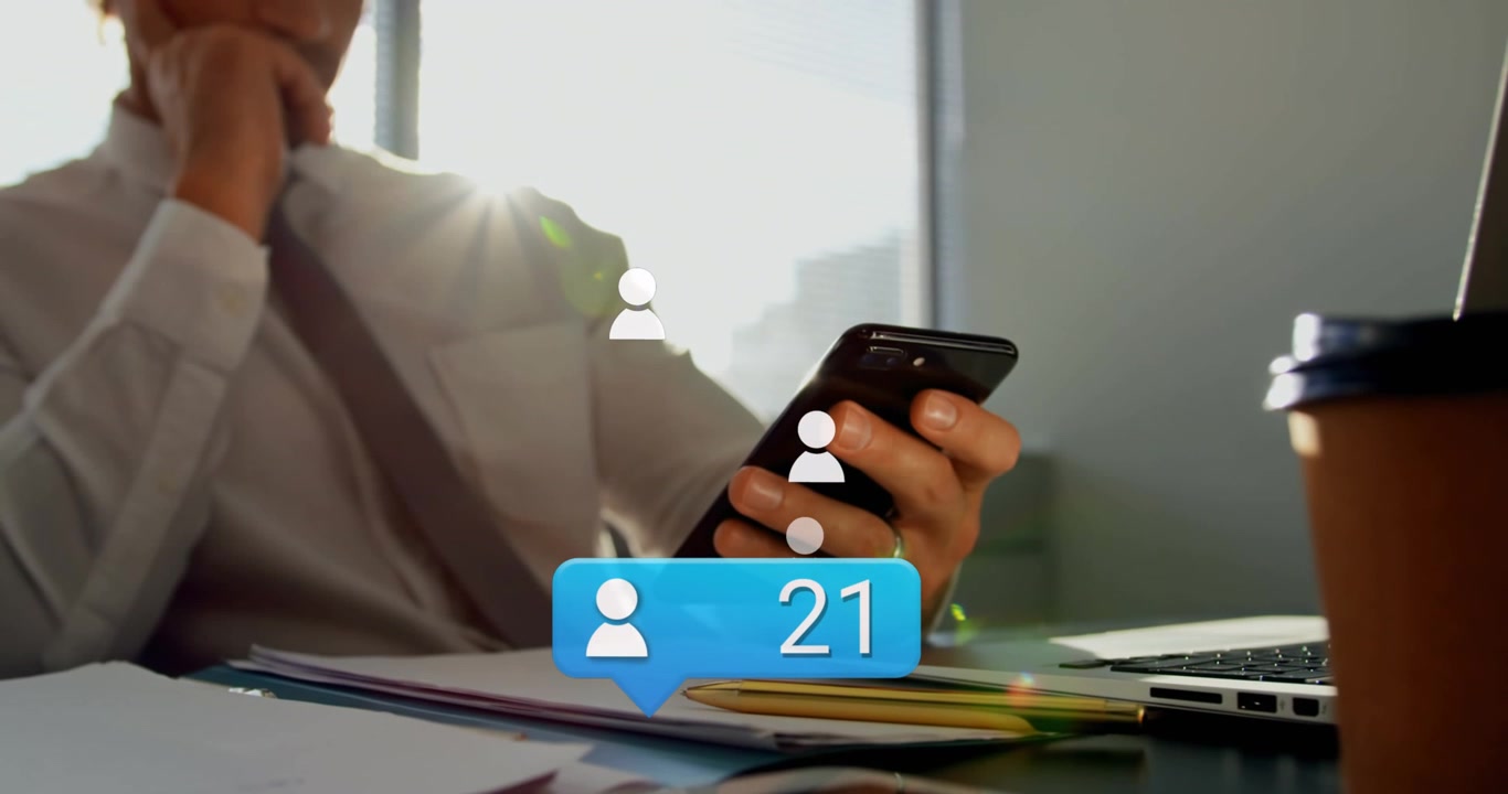 Animation of media icons over caucasian businessman using smartphone
