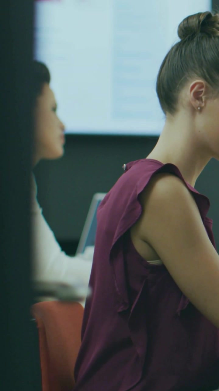 Vertical video: Woman at desk sitting, incoming badges over her showing likes hearts for marketing