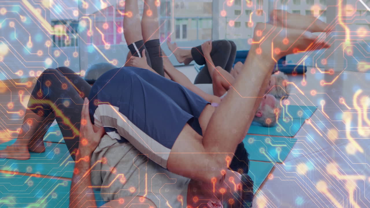 Exercising on mats, people with digital circuit overlay animation in gym
