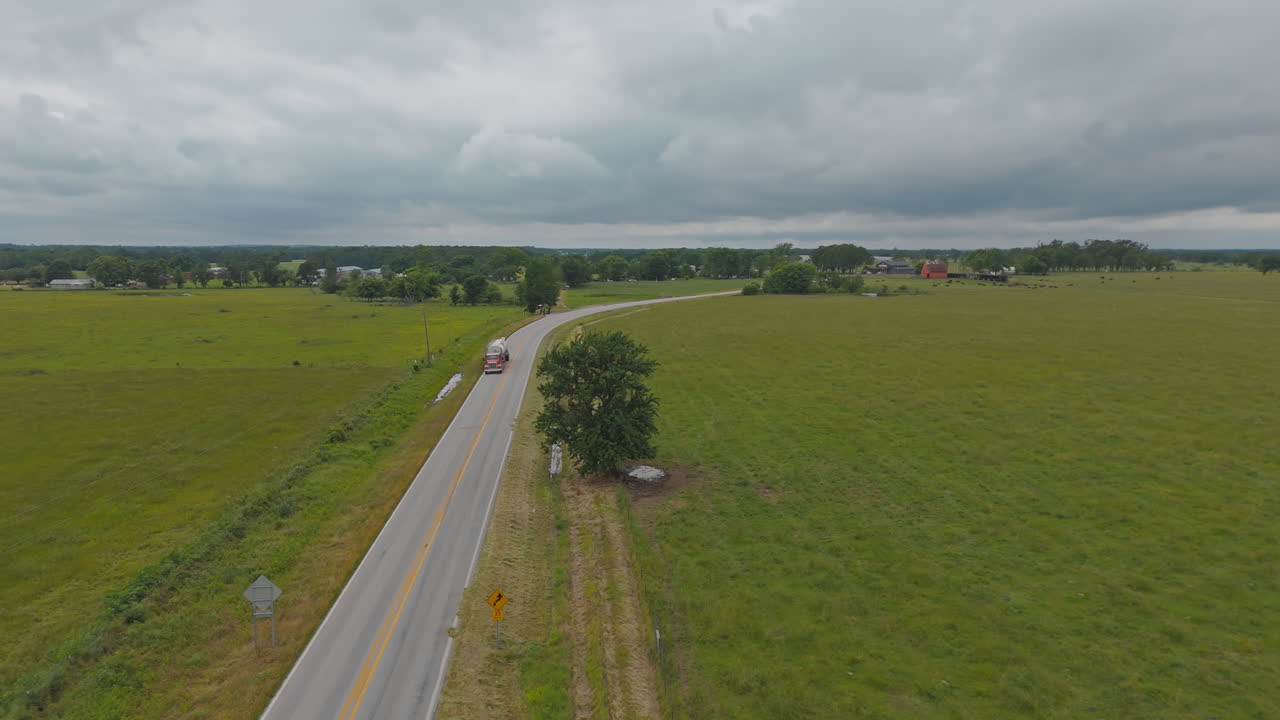 Country Road Between Green Fields In Cherokee City, Arkansas, USA - Aerial Drone Shot