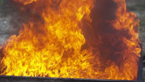 Close-up of intense yellow and orange flames burning, showcasing dramatic heat and energy