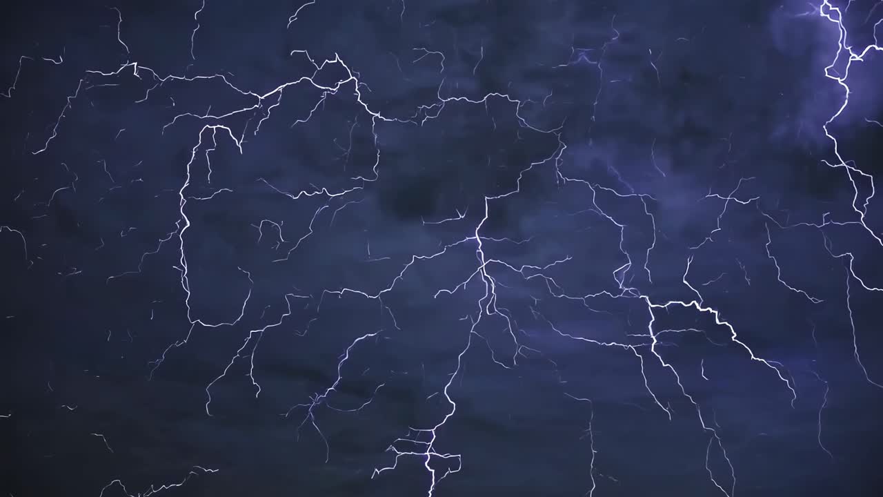 Dramatic video capture of lightning bolts across a stormy sky. Shot from a low angle