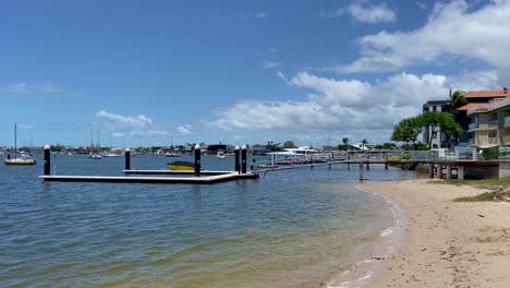 view along the tranquill shore at maloolaba, past waterfront perpaties and private moorings