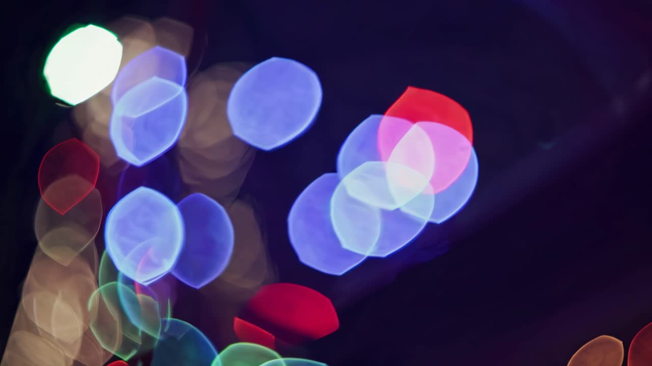 Abstract video concept with colorful bokeh lights against a dark background