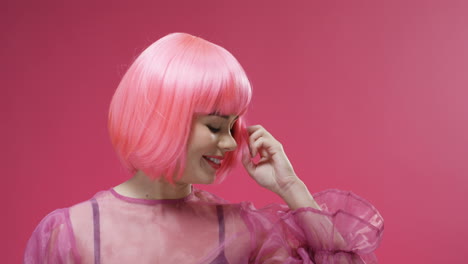 Portrait-Of-A-Beautiful-Woman-Wearing-A-Pink-Wig-Dancing-And-Laughing