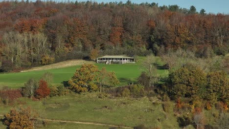 hillside cricket pitch autumn countryside uk aerial view sheepscombe cotswolds gloucestershire uk