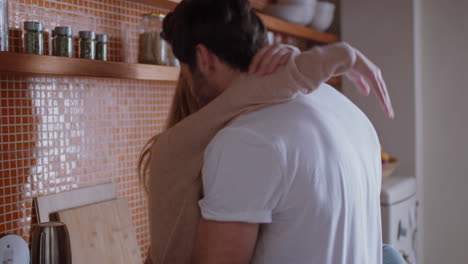 cheerful young couple hugging in kitchen having fun romantic relationship embracing sharing intimate connection enjoying happy lifestyle together