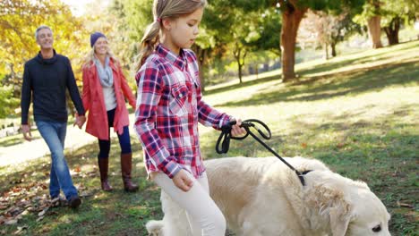 family walking with dog outdoors