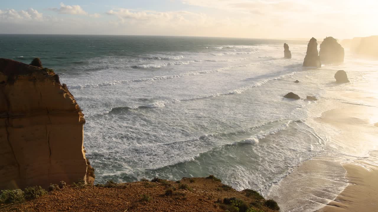 Waves crashing against iconic limestone stacks