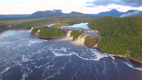 aerial view of canaima's lagoon, with the waterfalls and the tepuy mountains at the back