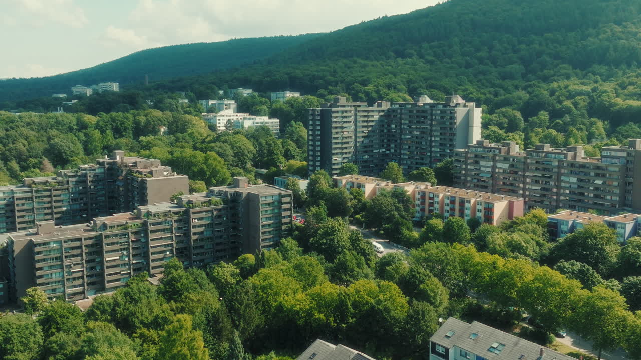 Dolly out drone shot of Emmertsgrund neighborhood and cityscape during the day in Heidelberg, state of Baden-Wurttemberg, Germany