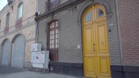 yellow door on a brick building in a city street
