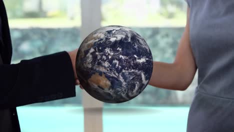 Animation-of-globe-over-businessman-handshake