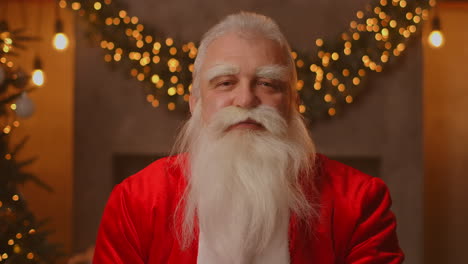 close up of grey-haired santa clause in glasses looking at camera. headshot portrait of funny old kind bearded santa claus face. saint nicholas greeting on merry christmas. high quality 4k footage