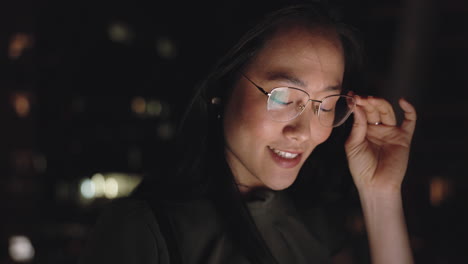 night, screen and asian woman with glasses in city