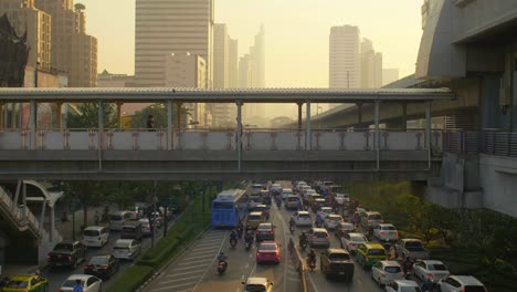 footbridge and traffic in bangkok at sunset