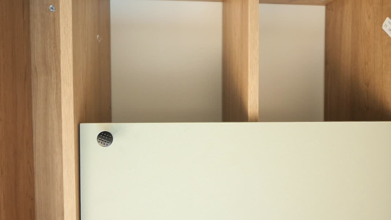 White cabinet with wooden frame and handles