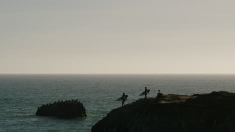 surfers going to surf in santa cruz, california