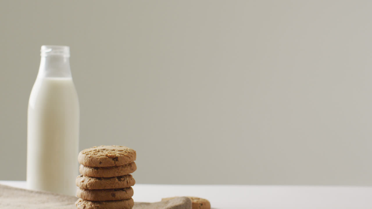 Video of biscuits with chocolate and milk on white background