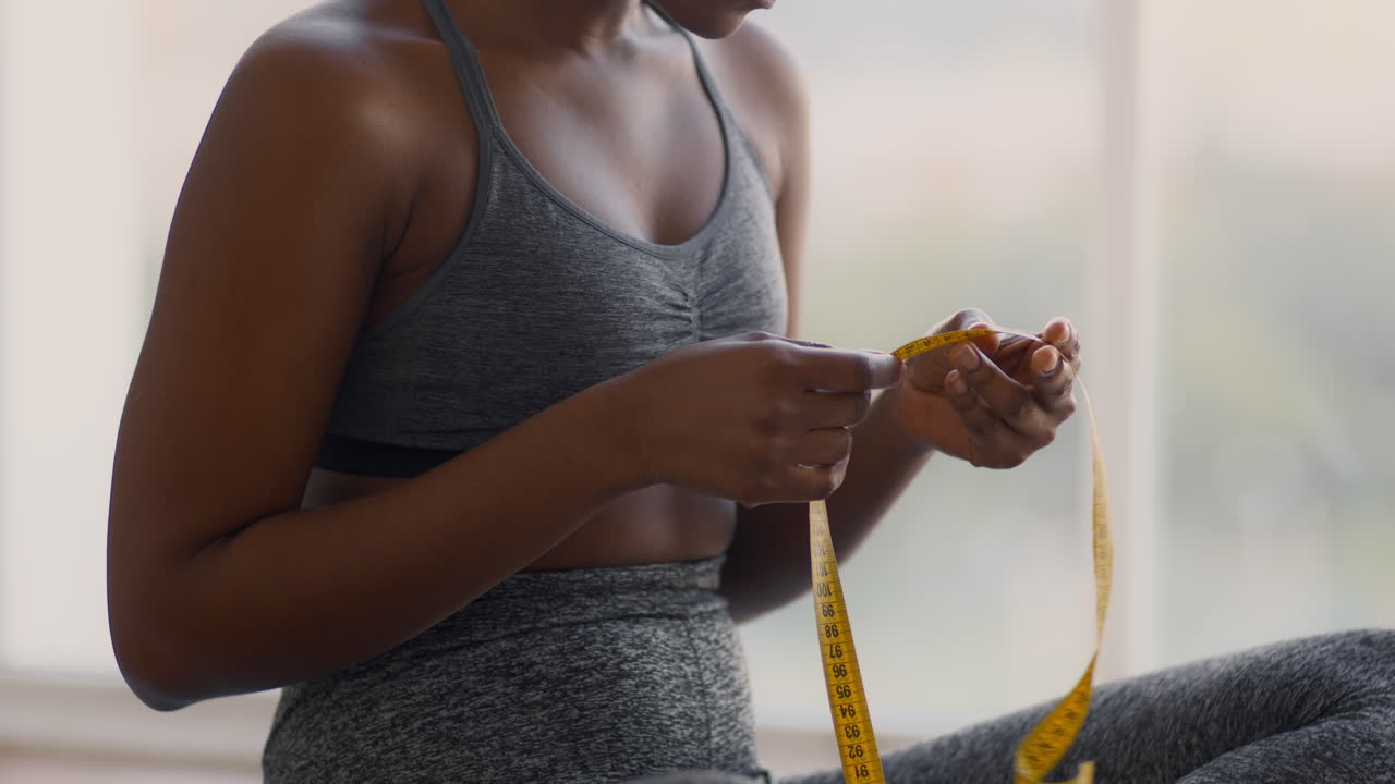 Woman Measuring Body with Tape Measure