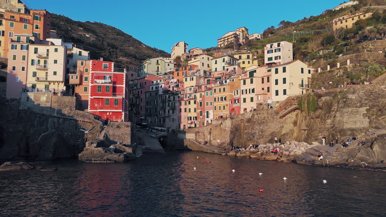 Colorful buildings on a rocky coastline in Riomaggiore, Cinque Terre, Italy