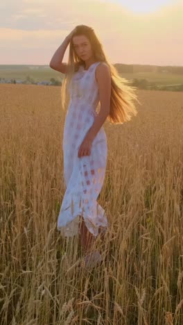 woman in a white dress in a wheat field at sunset