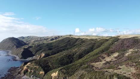 Tracking-shot-from-a-wind-farm-to-an-ocean-view