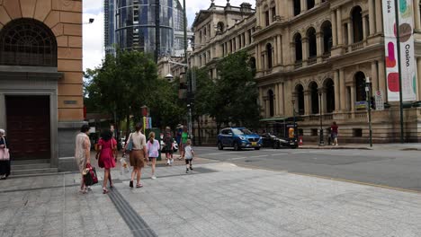 group of people walking across a city square