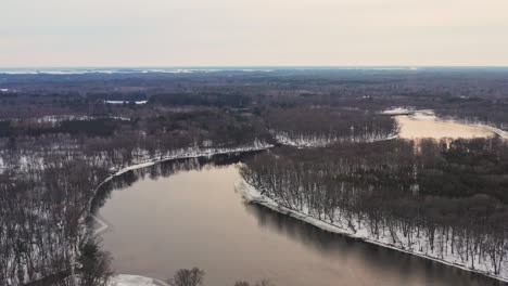 aerial, winding wisconsin river during winter season on an overcast day